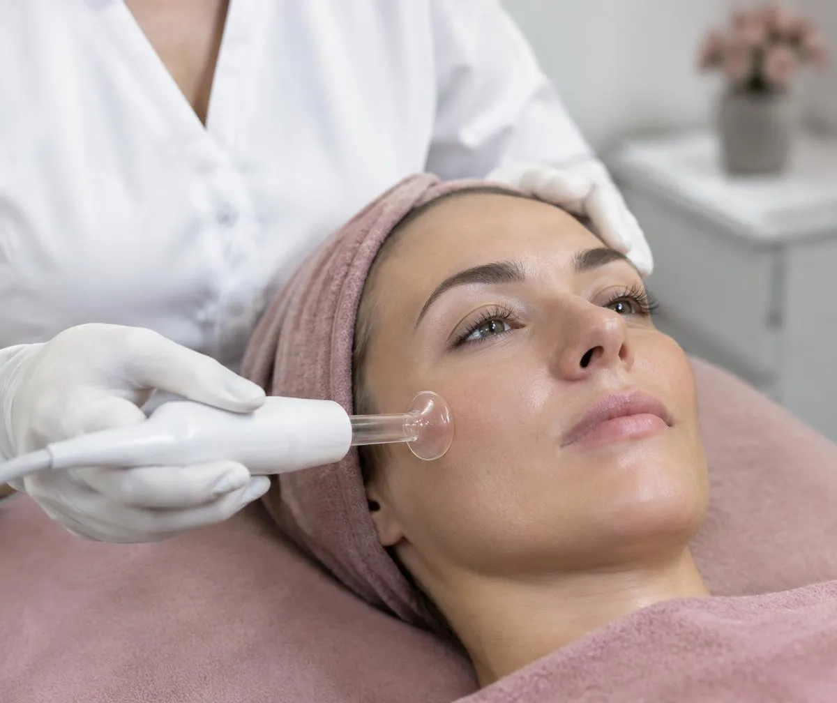 Illustrative practitioner using a glass high-frequency facial electrode